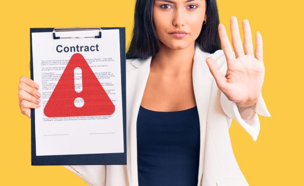 A woman holding up a clipboard with a large warning icon on the top page